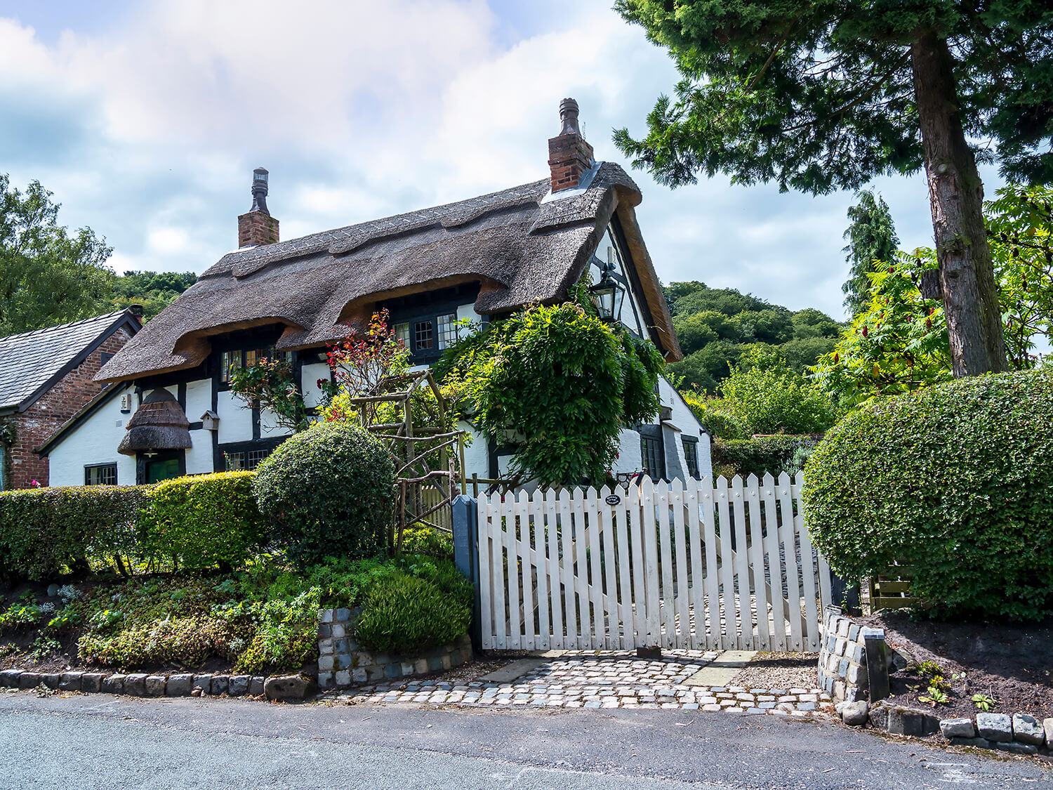 Family home with white picket fence in Alderley Edge, Cheshire, representing local living and legal support.