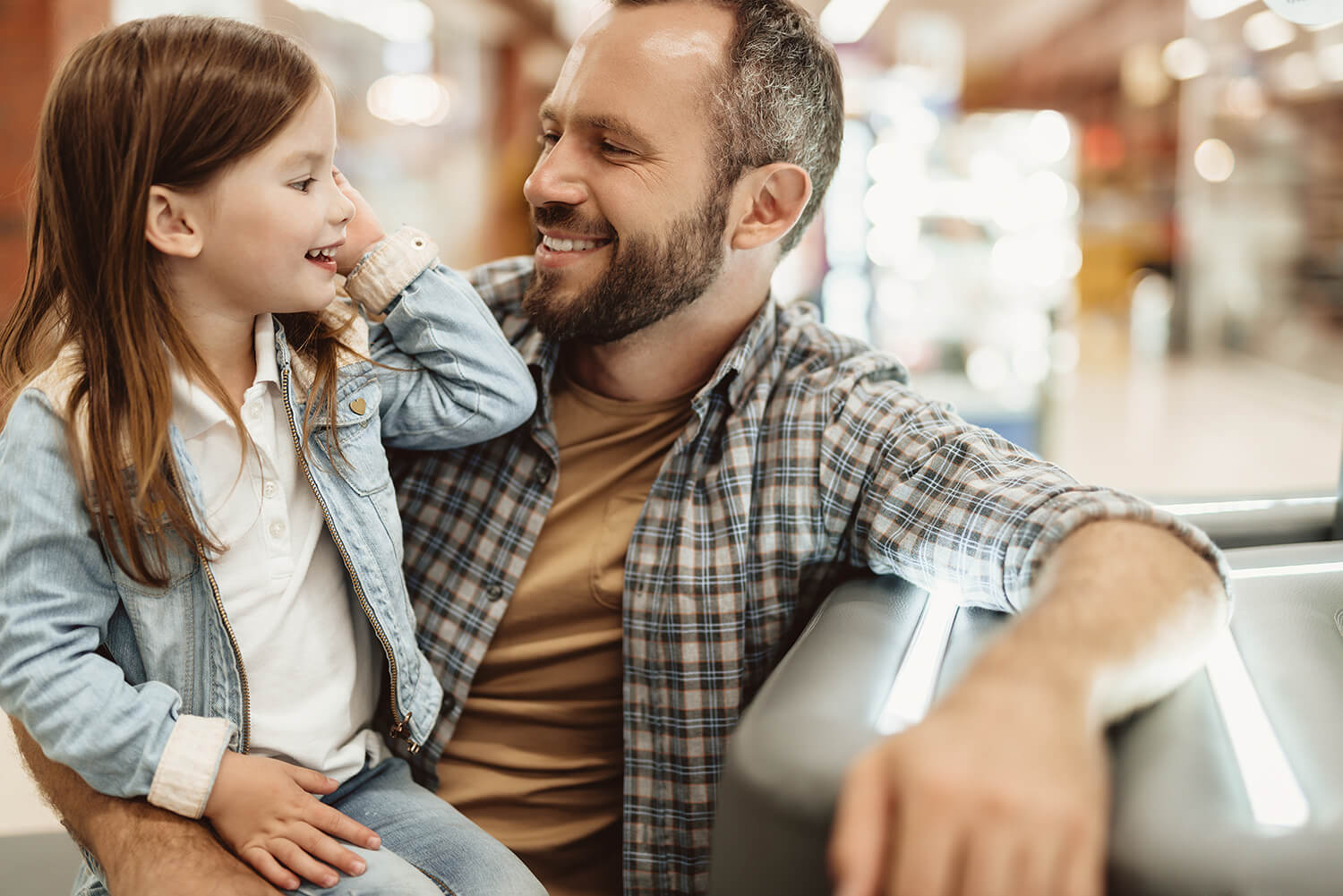 Smiling father and daughter spending time together indoors, representing co-parenting support in Altrincham.
