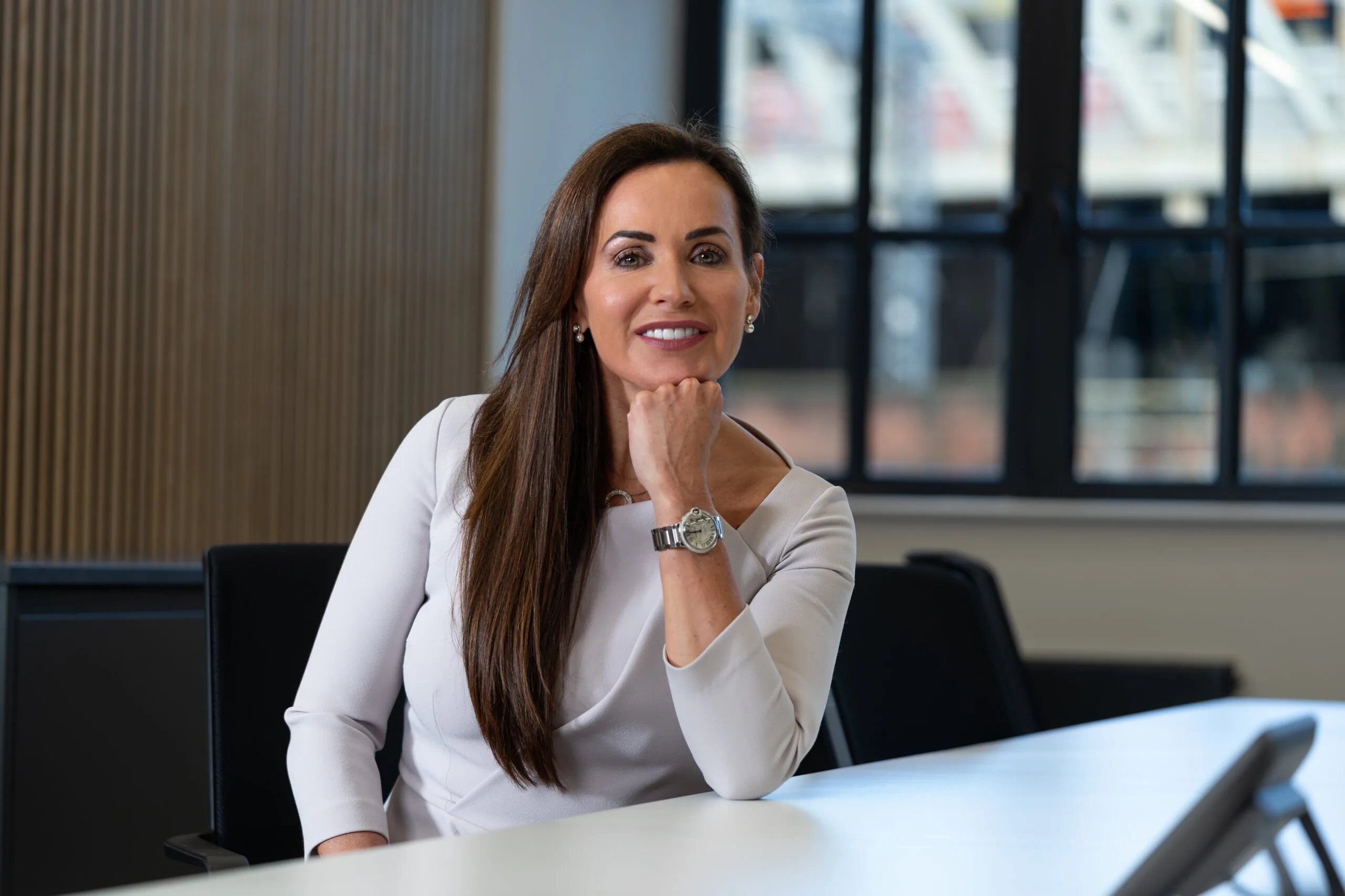 Amanda McAlister smiling at her desk in the London office of McAlister Family Law.