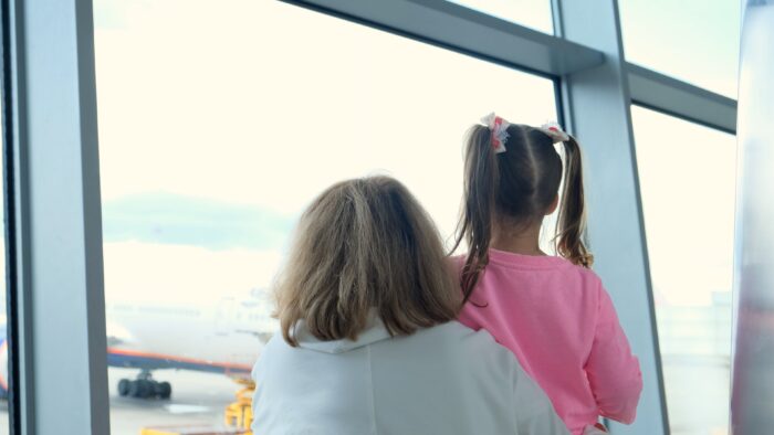 Happy,Mother,And,Little,Girl,At,The,Airport,In,Anticipation